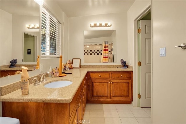 bathroom with a shower with shower curtain, tile patterned flooring, and vanity