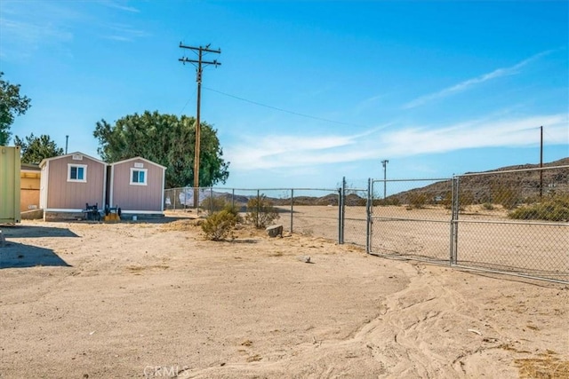 view of yard with fence and a gate