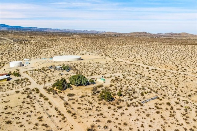 drone / aerial view with view of desert and a mountain view