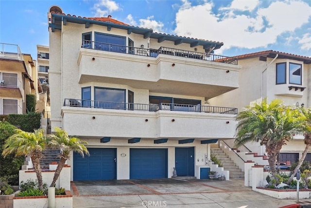 exterior space featuring a garage and stairway