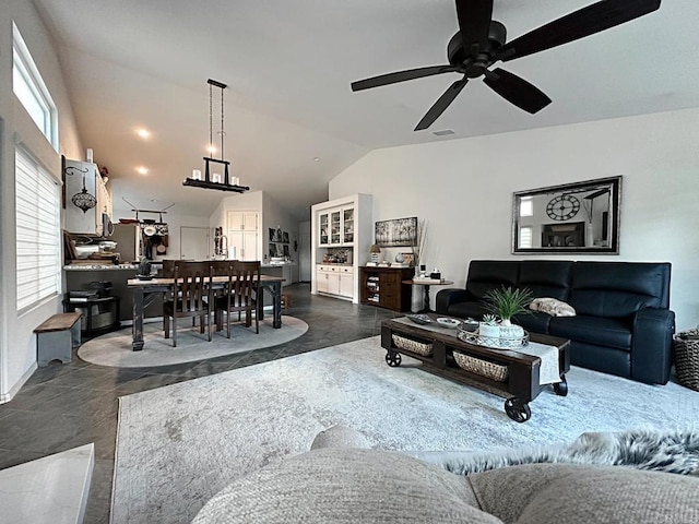 living room featuring lofted ceiling, ceiling fan, and visible vents