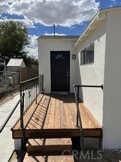 doorway to property featuring a balcony and stucco siding