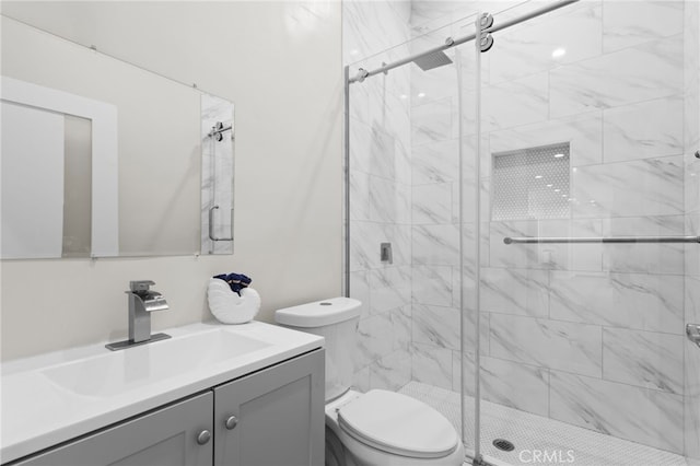 full bath featuring a shower stall, toilet, and vanity