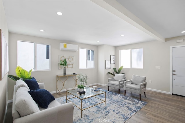 living area featuring recessed lighting, a wall mounted air conditioner, wood finished floors, and baseboards