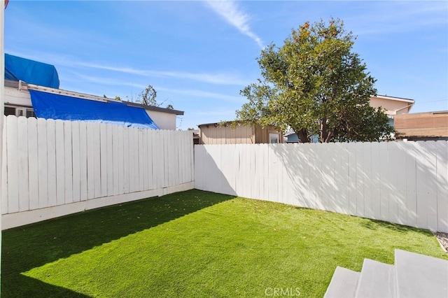 view of yard featuring a fenced backyard