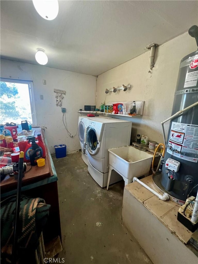 laundry area featuring secured water heater, laundry area, a sink, and washing machine and clothes dryer