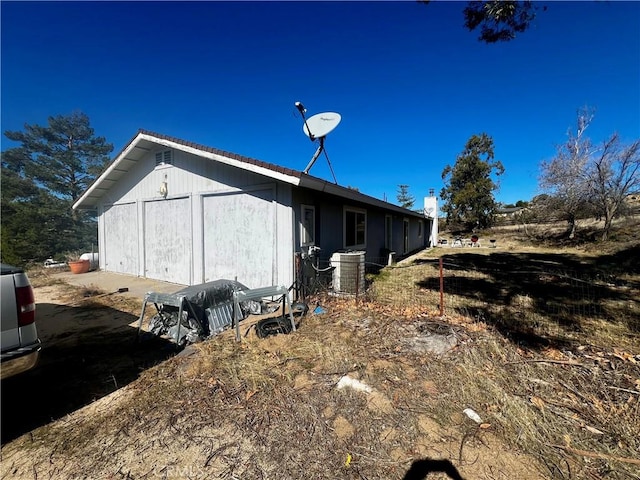 view of side of property with central air condition unit