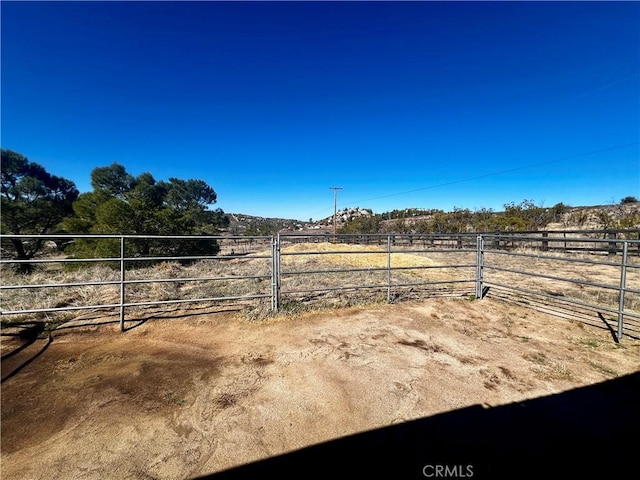 view of yard with a rural view and fence