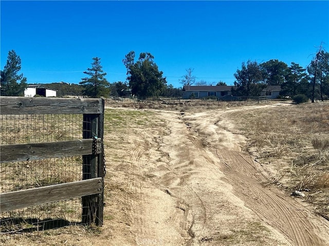 view of gate with a rural view