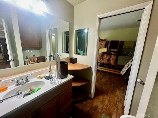 bathroom with wood finished floors and vanity