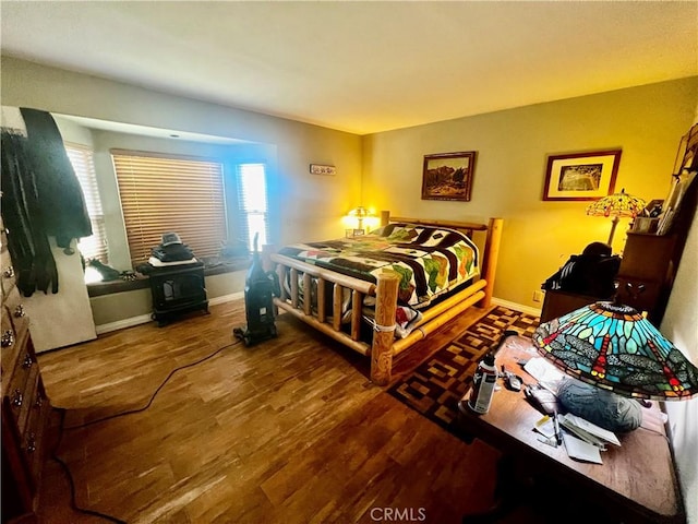 bedroom featuring wood finished floors and baseboards