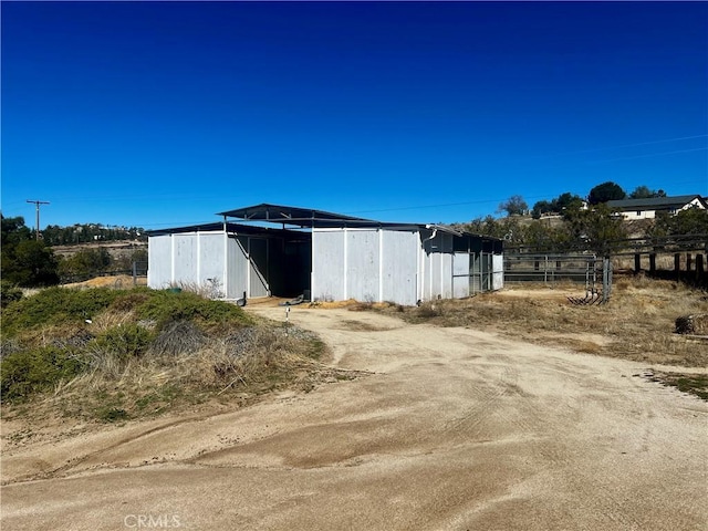 view of pole building featuring fence