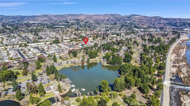 birds eye view of property featuring a water and mountain view