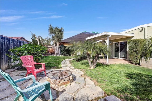 view of patio featuring a fire pit and a fenced backyard