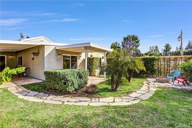 view of yard featuring a patio and an outdoor fire pit