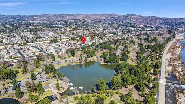 birds eye view of property featuring a water and mountain view