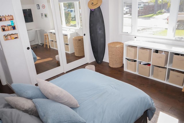 bedroom with dark wood-style flooring