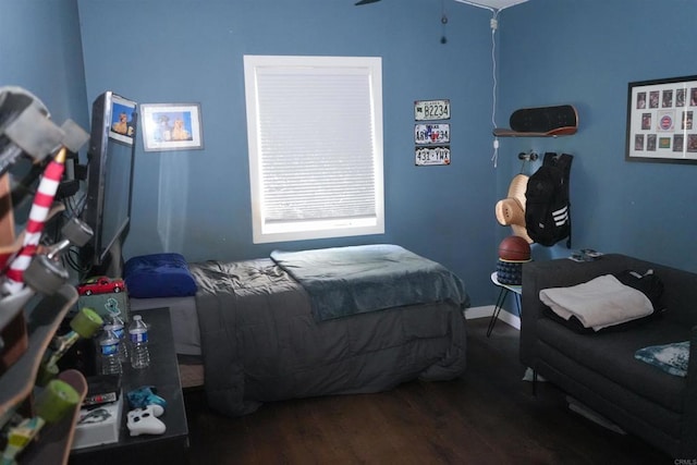 bedroom with dark wood finished floors