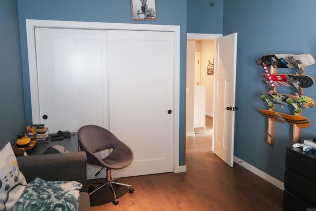 living area featuring dark wood-type flooring and baseboards