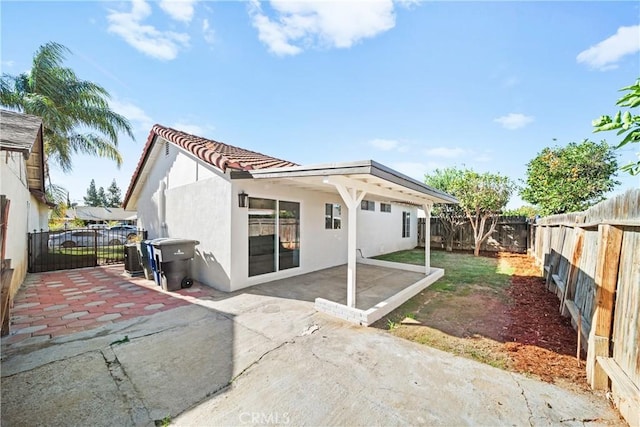 back of house featuring a patio area, a fenced backyard, and stucco siding