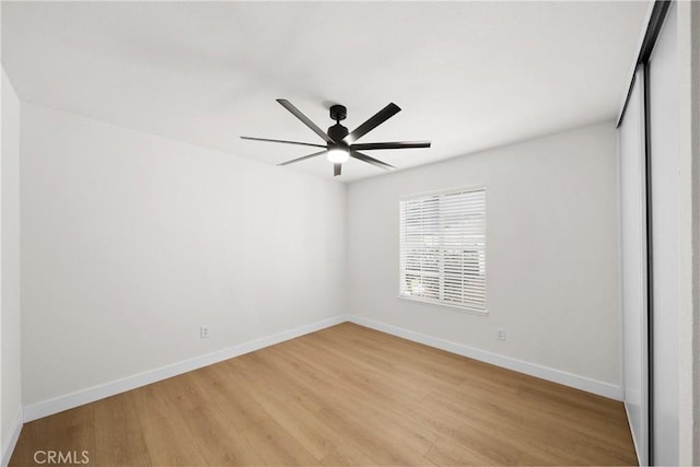 unfurnished bedroom featuring baseboards, a ceiling fan, and light wood-style floors