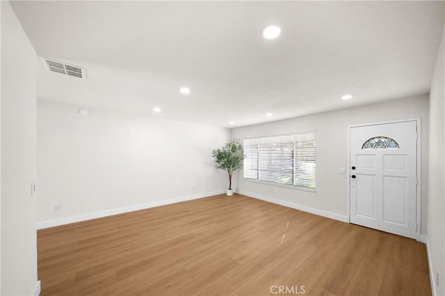 entrance foyer with recessed lighting, visible vents, light wood-style flooring, and baseboards