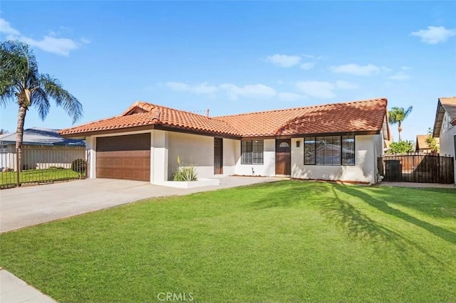 mediterranean / spanish-style home with fence, a front lawn, stucco siding, an attached garage, and a tile roof