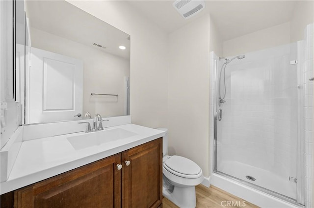 full bathroom featuring toilet, a shower stall, visible vents, and vanity