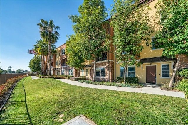 surrounding community featuring a yard and fence