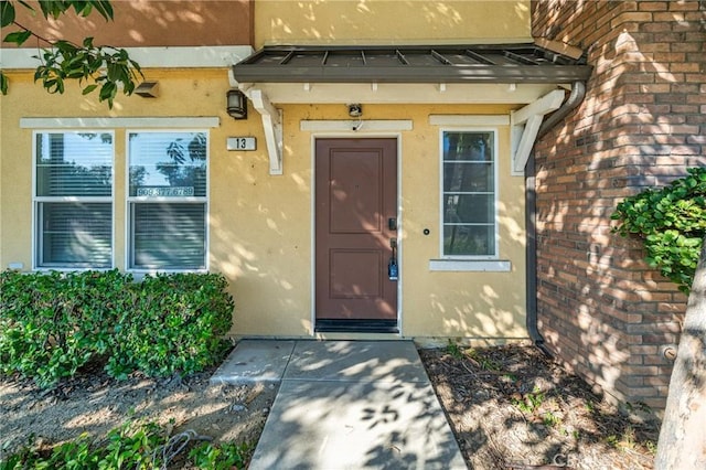 view of exterior entry featuring stucco siding