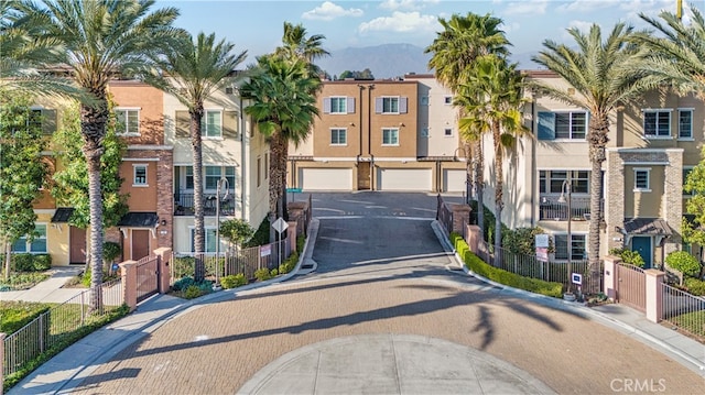 exterior space featuring driveway, fence, and a mountain view