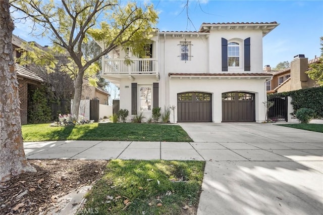 mediterranean / spanish-style house featuring concrete driveway, a balcony, a tile roof, a gate, and fence