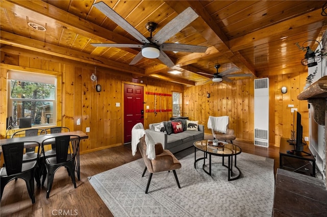 living area featuring visible vents, beamed ceiling, wood ceiling, wood finished floors, and a ceiling fan