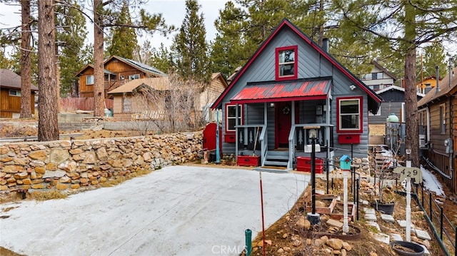 view of front of house featuring a porch and metal roof
