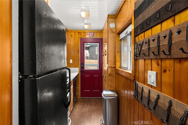 interior space featuring wooden walls and wood finished floors