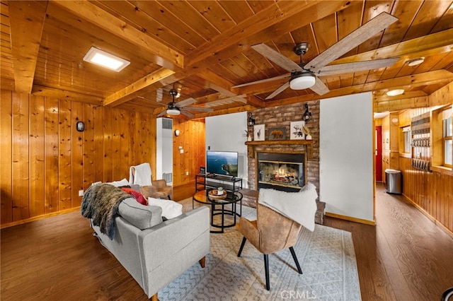 living room with beam ceiling, wood ceiling, wood finished floors, and a fireplace