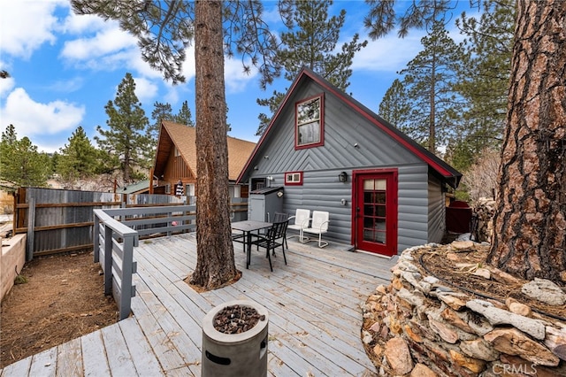 wooden deck featuring outdoor dining area and fence