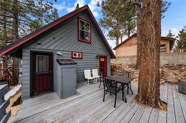 wooden terrace with an outbuilding and fence