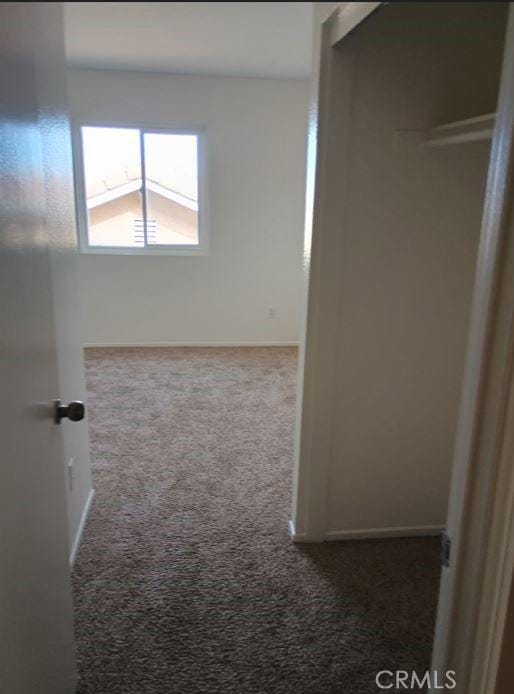 interior space featuring baseboards and carpet flooring