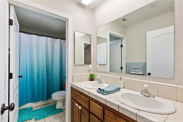 full bathroom with double vanity, a sink, visible vents, and tile patterned floors