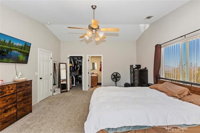 bedroom with ceiling fan, connected bathroom, light colored carpet, visible vents, and vaulted ceiling