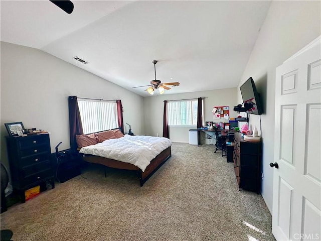 bedroom featuring carpet floors, visible vents, vaulted ceiling, and a ceiling fan