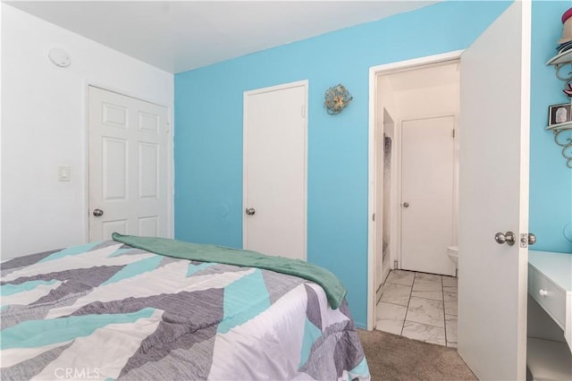 bedroom with marble finish floor and light colored carpet