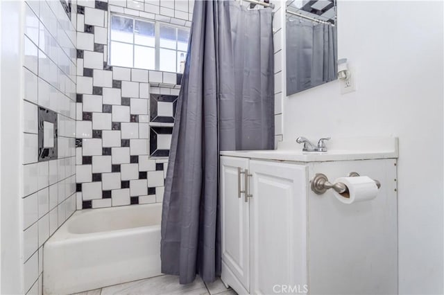 bathroom featuring shower / bath combo with shower curtain and vanity