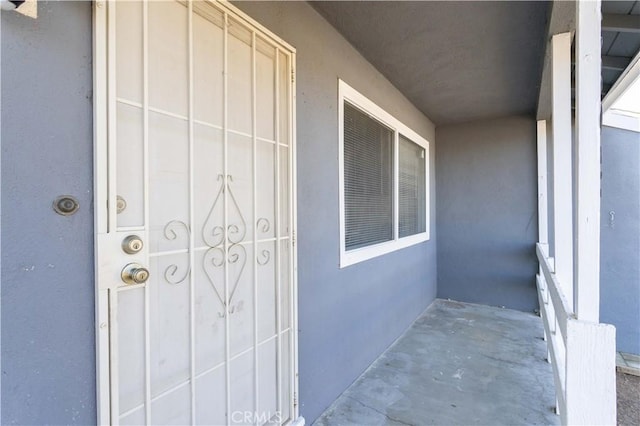 entrance to property featuring stucco siding