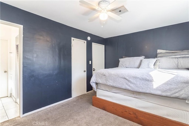 bedroom featuring a ceiling fan and light carpet