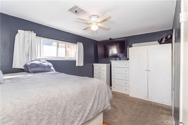 carpeted bedroom with ceiling fan and visible vents