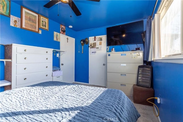 carpeted bedroom featuring a ceiling fan