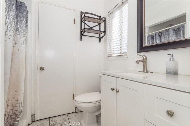 full bathroom with toilet and vanity