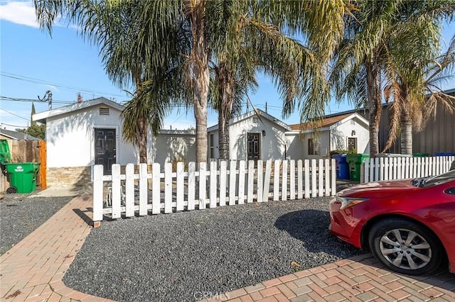 view of front of property featuring a fenced front yard and stucco siding